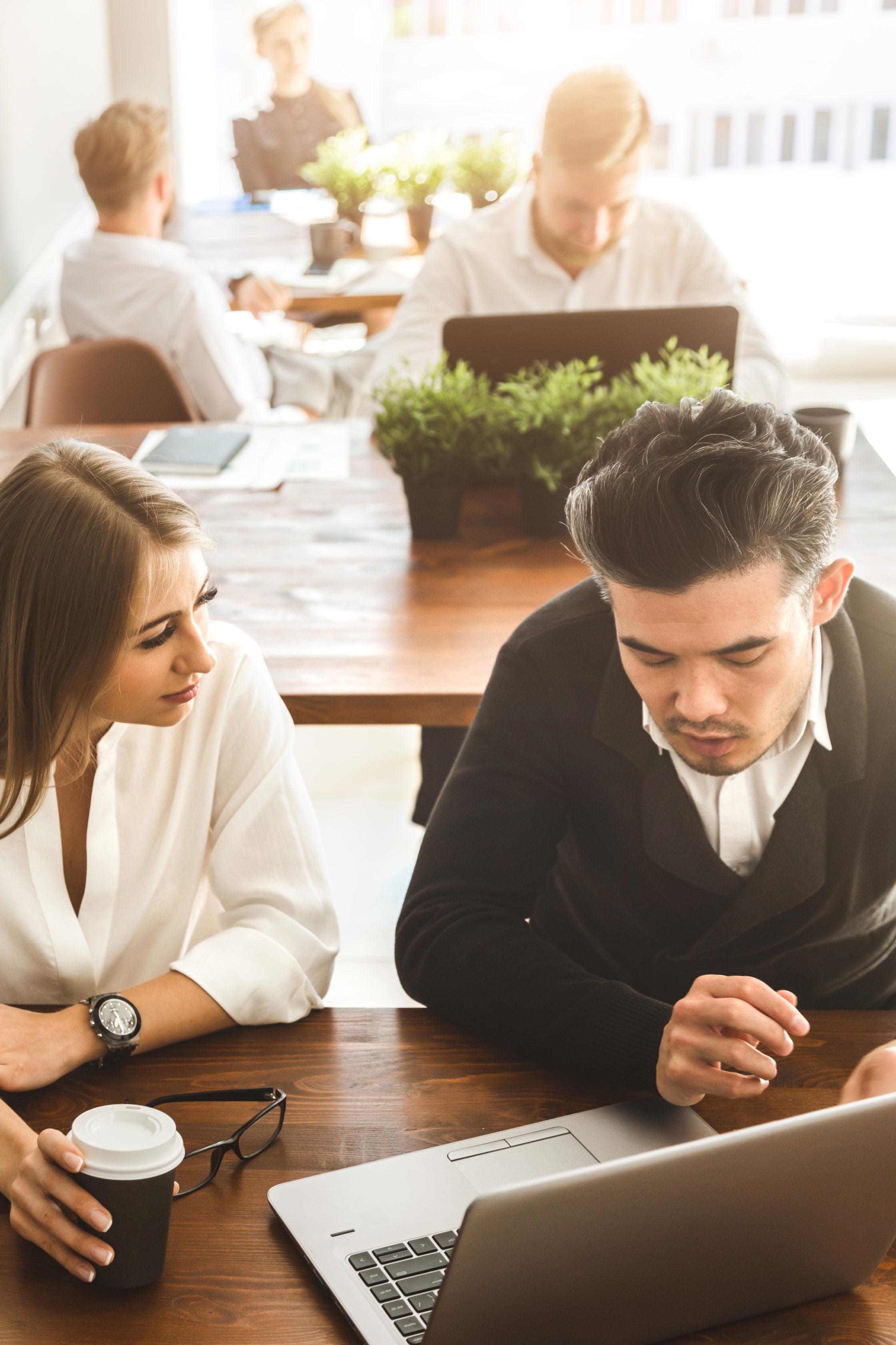 A team of young businessmen working and communicating together in an office. Corporate businessteam and manager in a meeting